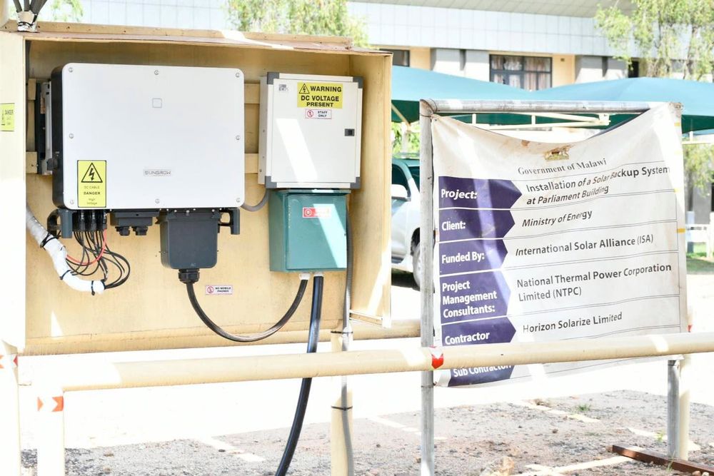 The solar inverter and switchgear mounted beside the project signboard at the Parliament Building